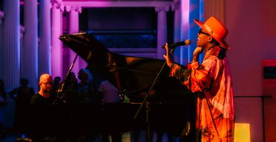 A musical performance with a singer and a piano player