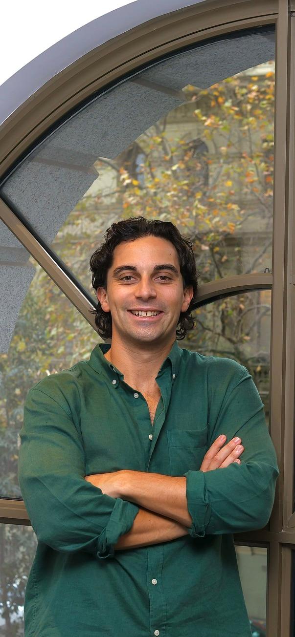 Man in green shirt with arms crossed.