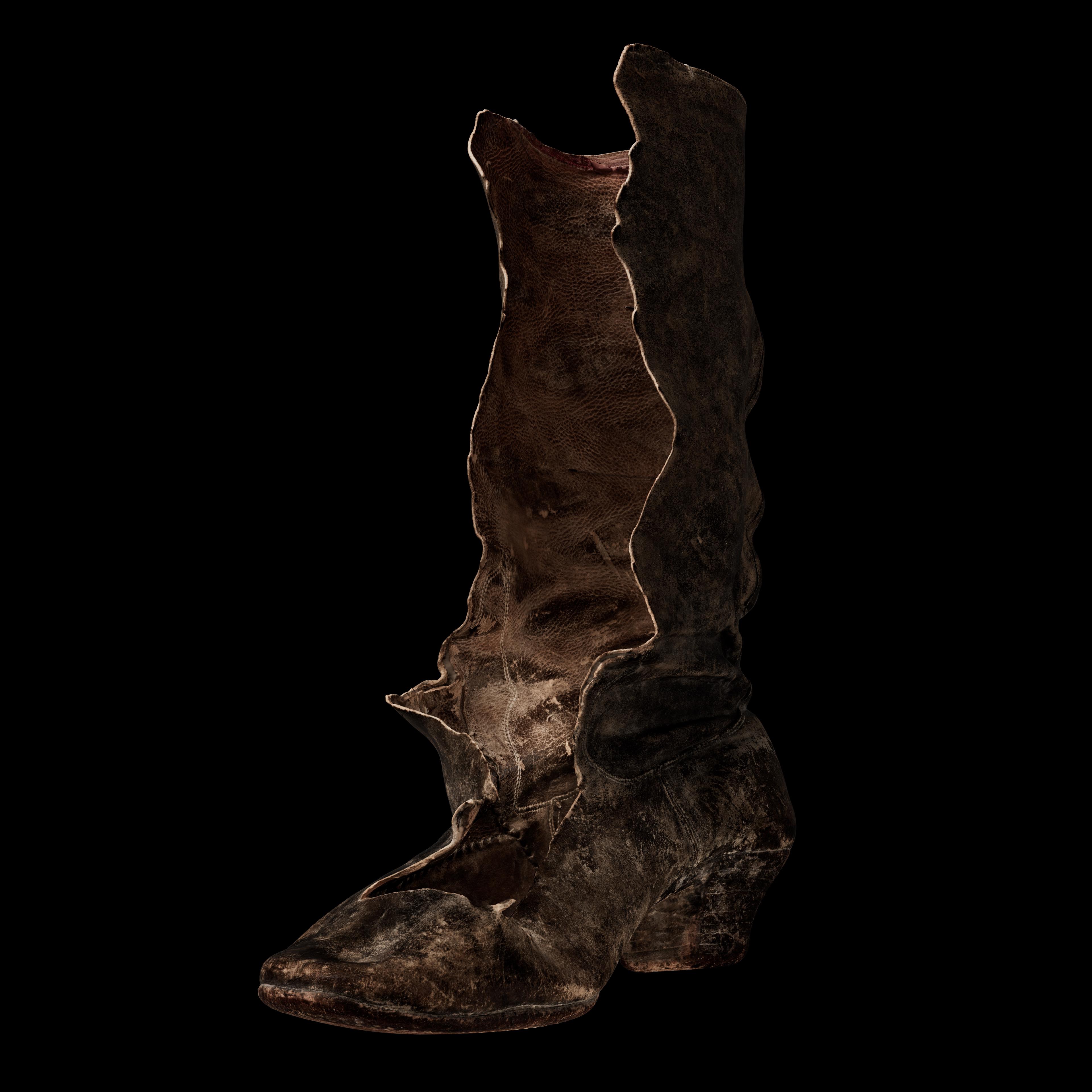 Digital render of a torn leather boot. Displayed at an offset angle.