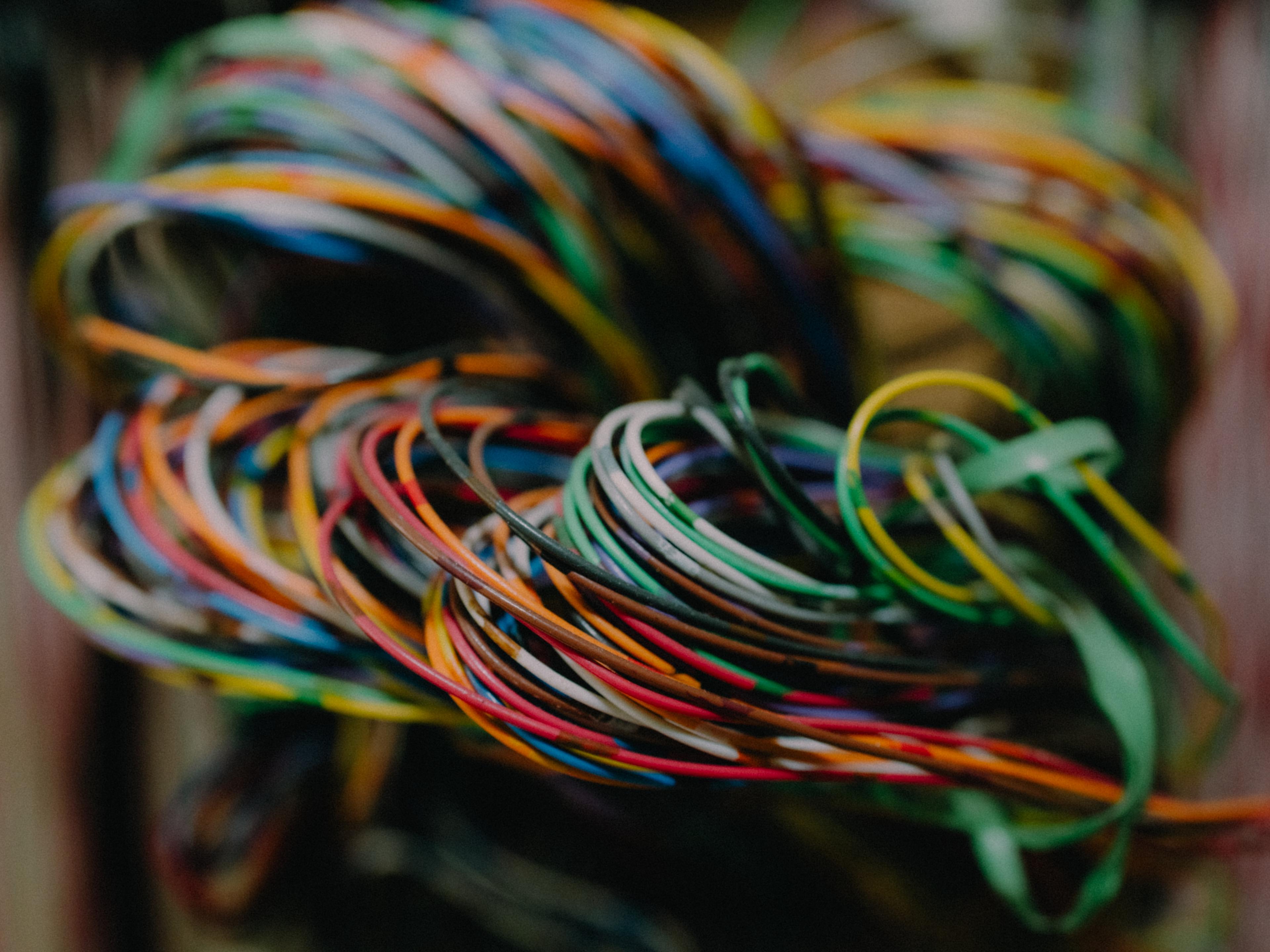Close up of bundles of multi-coloured electrical wires.